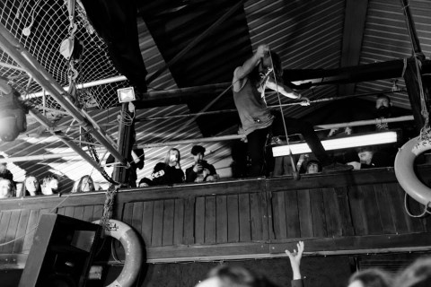 HECK Frontman, Matt Reynolds, scaling the walls like Spider-Man.